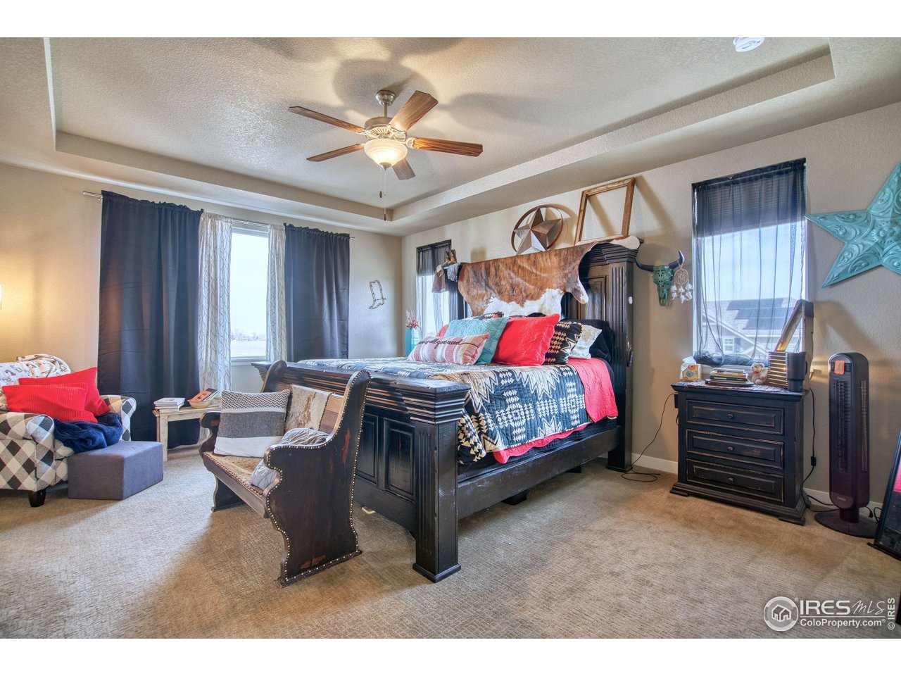 810 Ranchhand Drive Berthoud, CO 80513 - Photo 17 of 40 Generous primary suite presents a tray ceiling for additional height and is located away from other bedrooms.