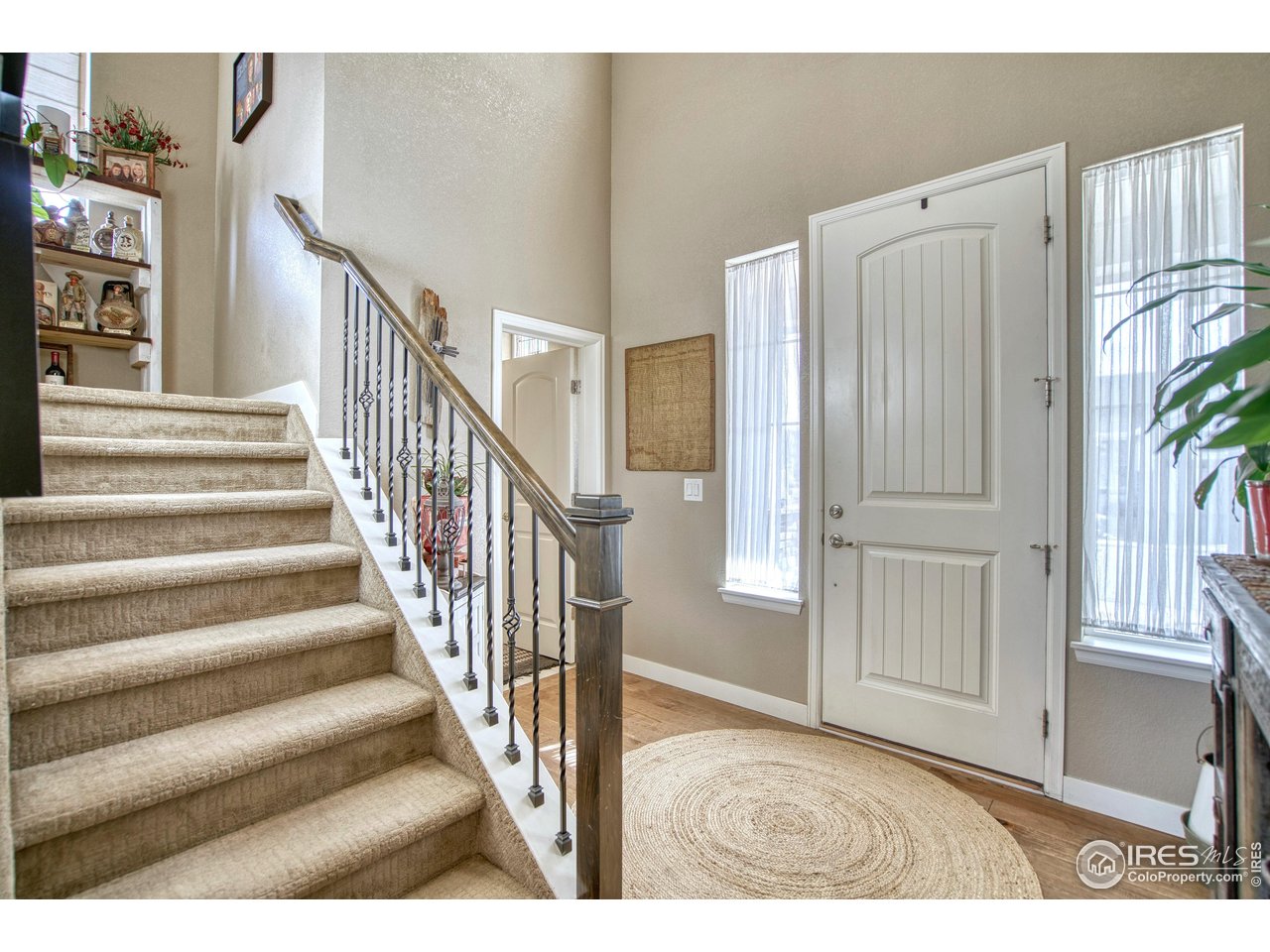 810 Ranchhand Drive Berthoud, CO 80513 - Photo 3 of 40 Enter to a dramatic 2-story foyer. Extensive manufactured wood flooring on the main level. Neutral color palette is pleasant.