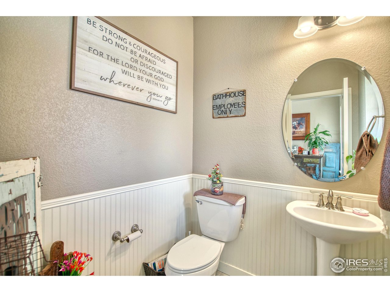 810 Ranchhand Drive Berthoud, CO 80513 - Photo 4 of 40 Main level powder room has decorative wainscoting.