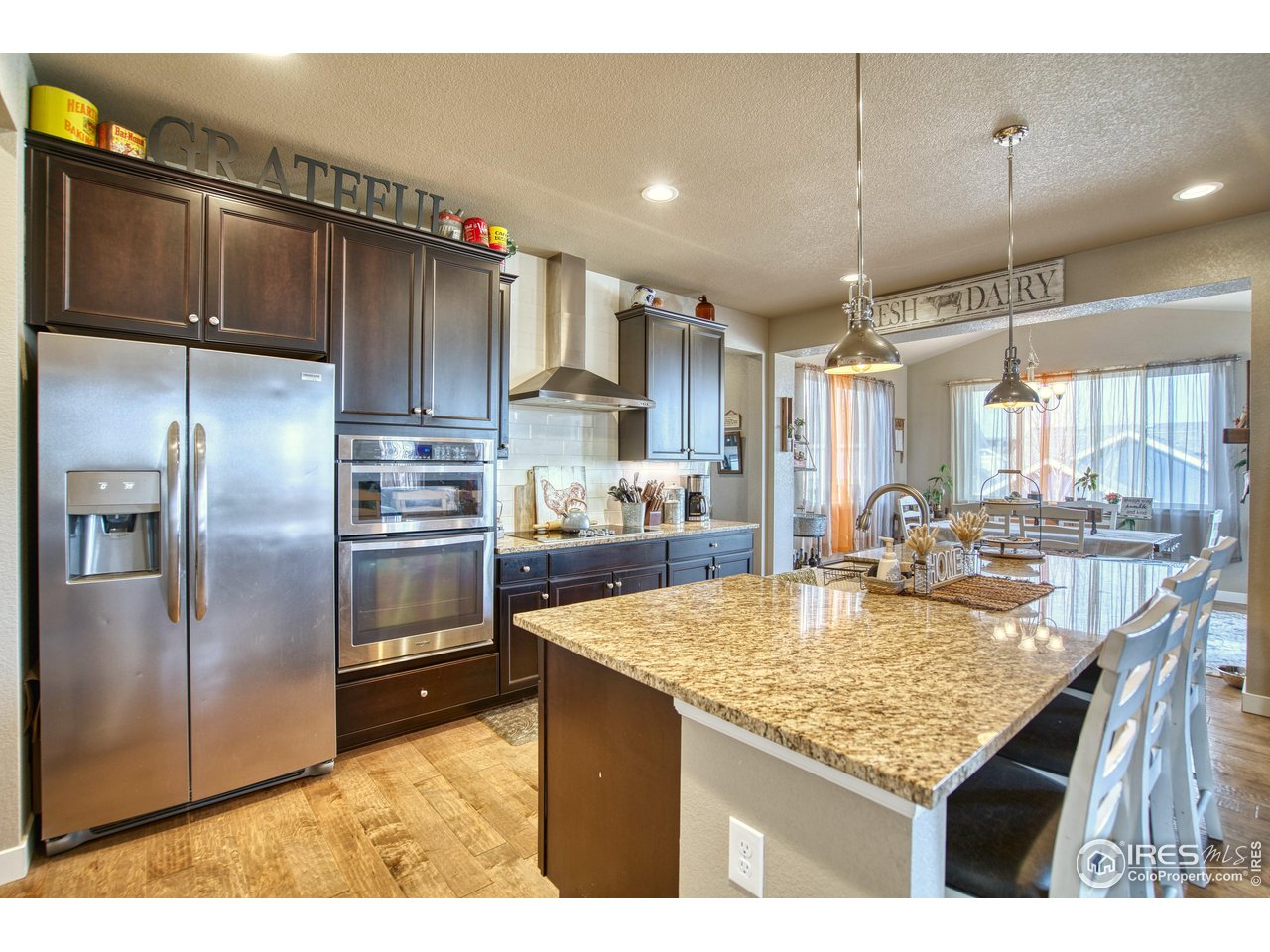 810 Ranchhand Drive Berthoud, CO 80513 - Photo 6 of 40 Chef's kitchen features granite counters, espresso cabinets & stainless appliances.
