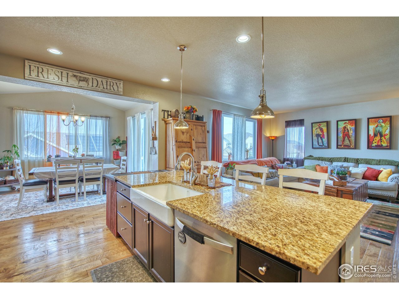 810 Ranchhand Drive Berthoud, CO 80513 - Photo 7 of 40 Large island with farm sink is a highlight. Snack bar for stools allows for additional seating.