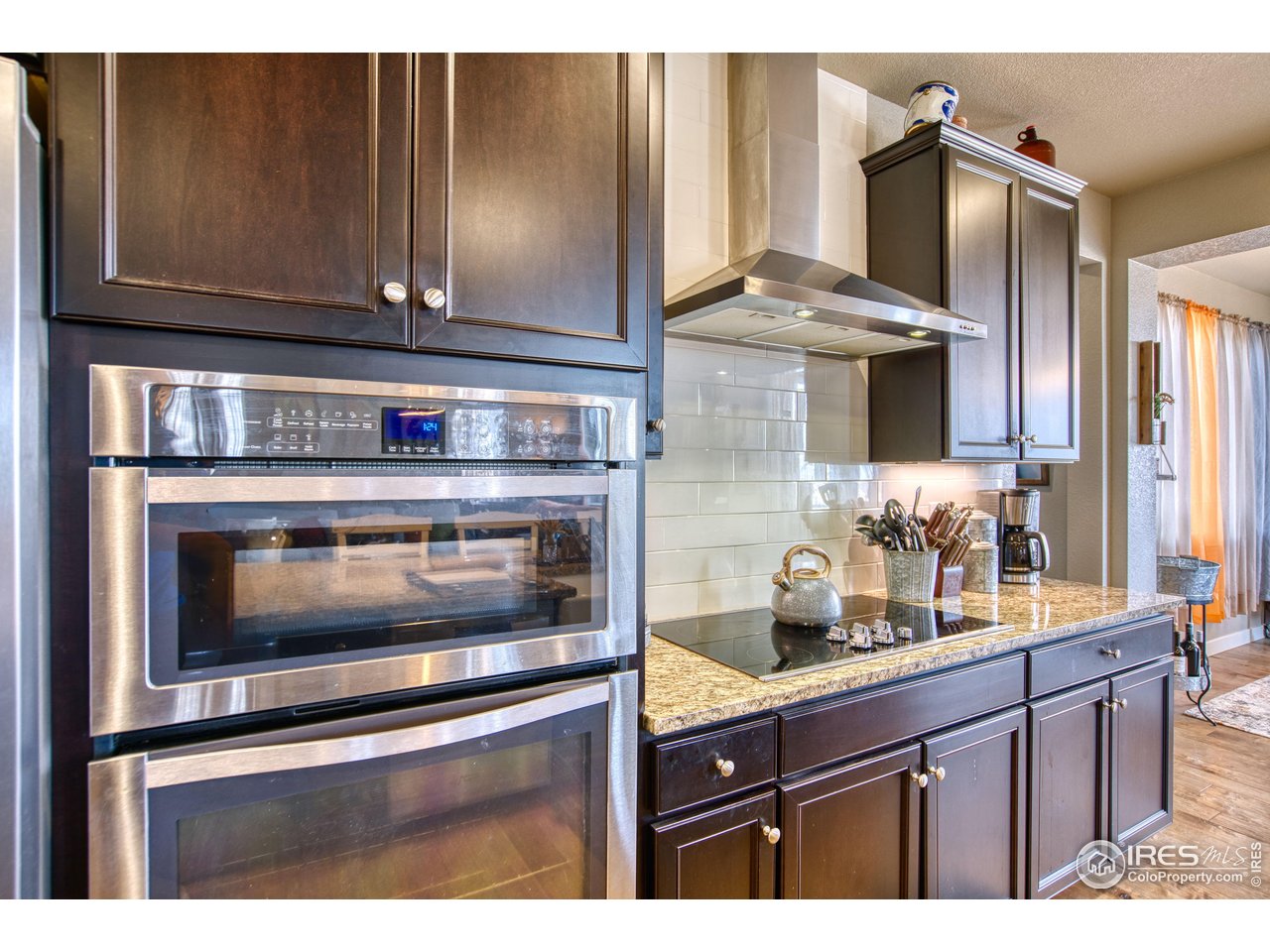 810 Ranchhand Drive Berthoud, CO 80513 - Photo 8 of 40 Microwave, wall oven, electric cooktop & hood make meal preparation a breeze. Subway tile backsplash is stylish.