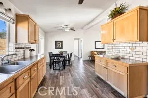 a large kitchen with kitchen island granite countertop a large window a sink and counter space