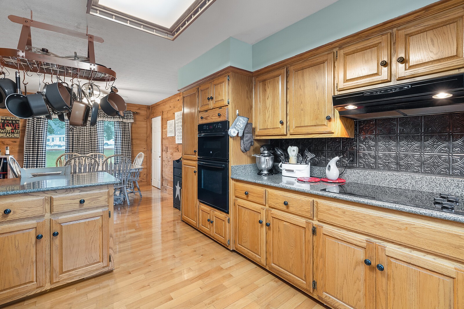 387 Ranch Road Portland, TN 37148 - Photo 13 of 39 a kitchen with stainless steel appliances granite countertop a refrigerator a sink dishwasher and white cabinets with wooden floor