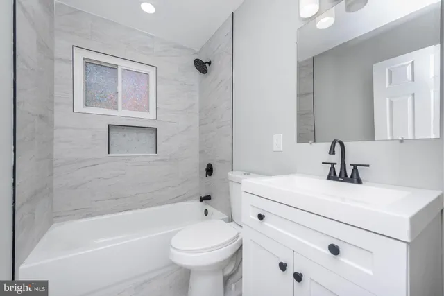 a bathroom with a sink a toilet and a bathtub