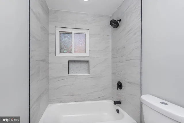a bathroom with a bathtub and a toilet