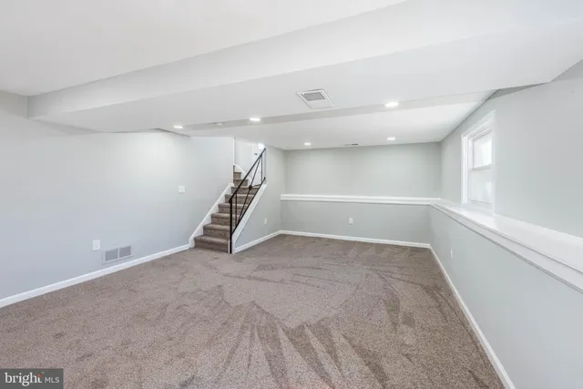 a view of an empty room with stairs