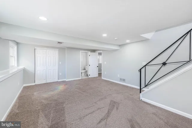 a view of an empty room with stairs