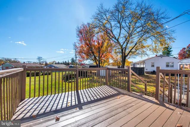 a view of balcony with wooden floor and fence