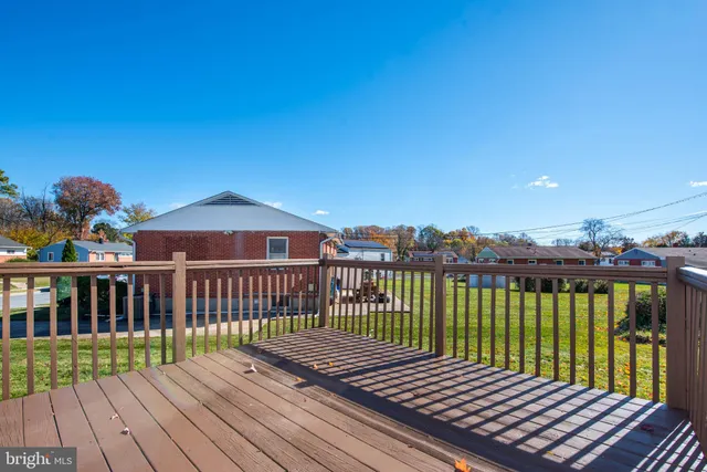 a view of a wooden deck with a yard