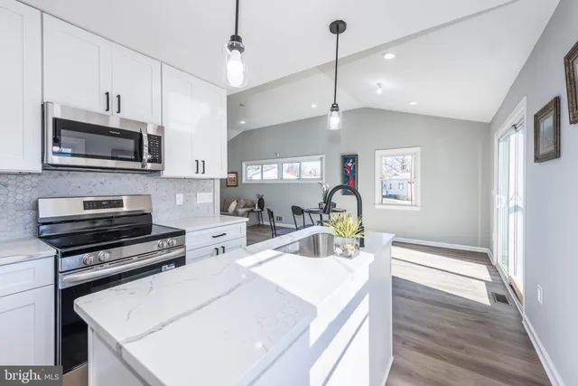 a kitchen with sink a microwave and stove