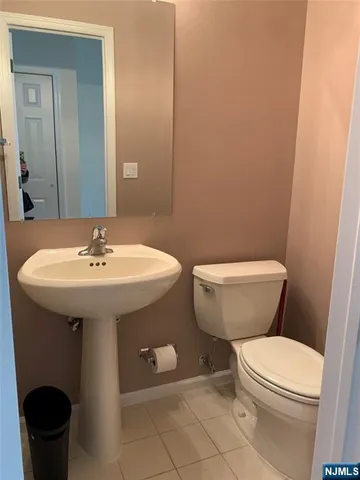a bathroom with a toilet a sink and a mirror