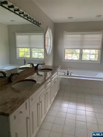 a large white kitchen with a large window
