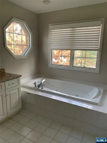 a room with a sink and a large mirror