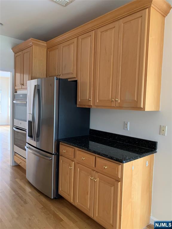 166 Stonegate Trail Cresskill, NJ 07626 - Photo 6 of 28 a kitchen with granite countertop a refrigerator stove and cabinets