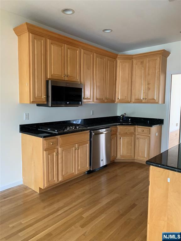 166 Stonegate Trail Cresskill, NJ 07626 - Photo 7 of 28 a kitchen with granite countertop wooden cabinets a sink and dishwasher