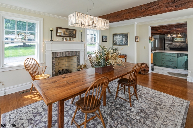 760 Rosemont Ringoes Road Stockton, NJ 08559 - Photo 14 of 49 a dining room with furniture wooden floor and a fireplace