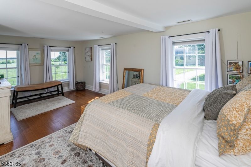 760 Rosemont Ringoes Road Stockton, NJ 08559 - Photo 20 of 49 a spacious bedroom with a bed and wooden floor