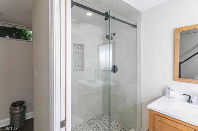 a bathroom with a shower and a sink