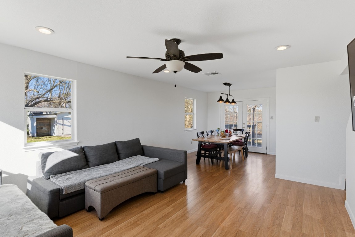 93 County Road 130 Georgetown, TX 78626 - Photo 11 of 27 a living room with furniture a dining table and a chandelier