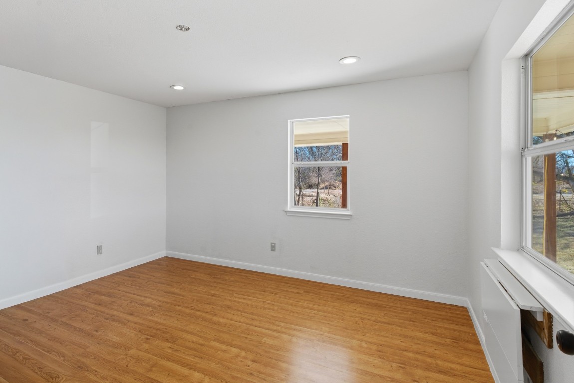 93 County Road 130 Georgetown, TX 78626 - Photo 12 of 27 wooden floor in an empty room with a window