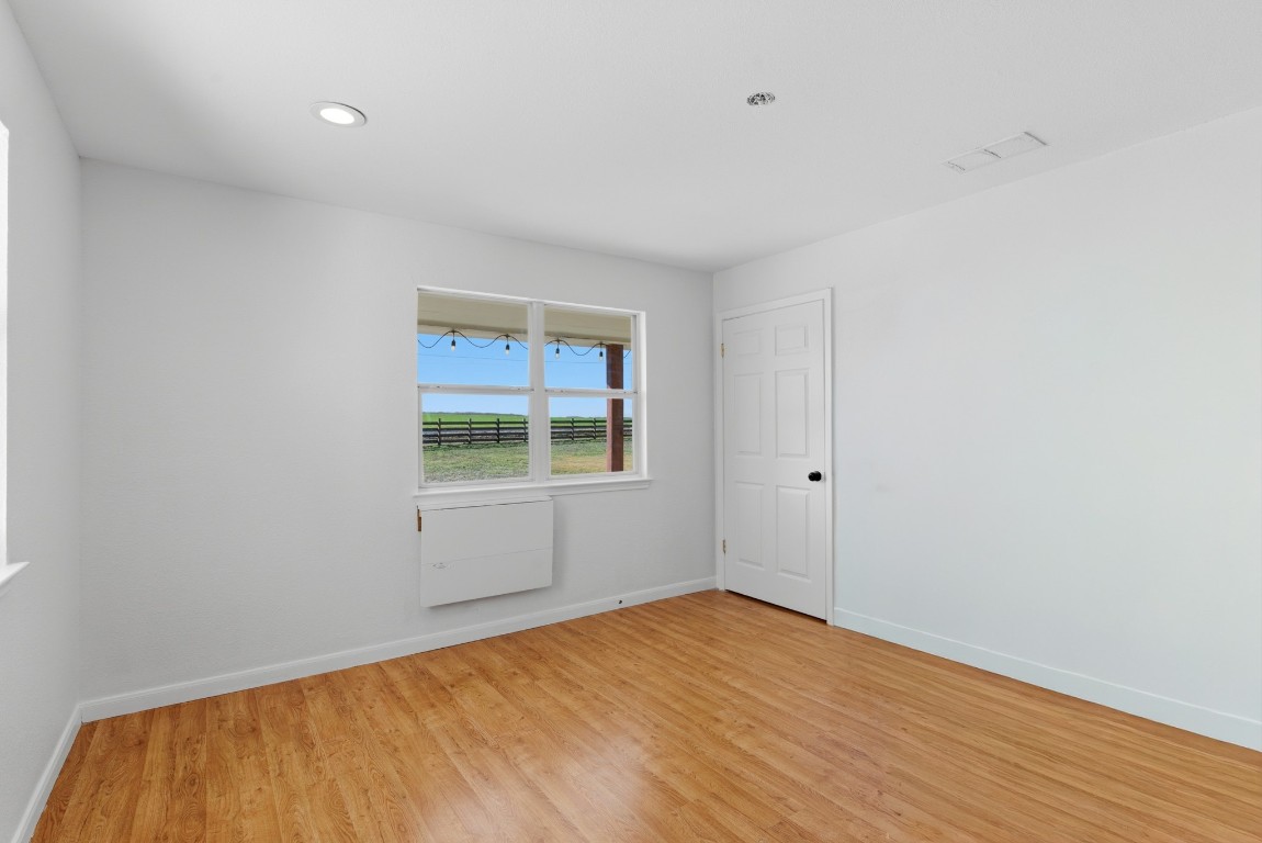 93 County Road 130 Georgetown, TX 78626 - Photo 14 of 27 a view of empty room with wooden floor and fan