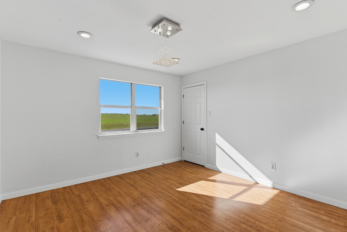 93 County Road 130 Georgetown, TX 78626 - Photo 16 of 27 an empty room with wooden floor and windows