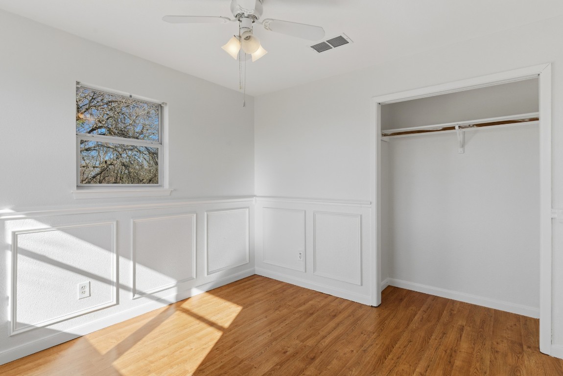 93 County Road 130 Georgetown, TX 78626 - Photo 19 of 27 a view of an empty room with wooden floor and a ceiling fan