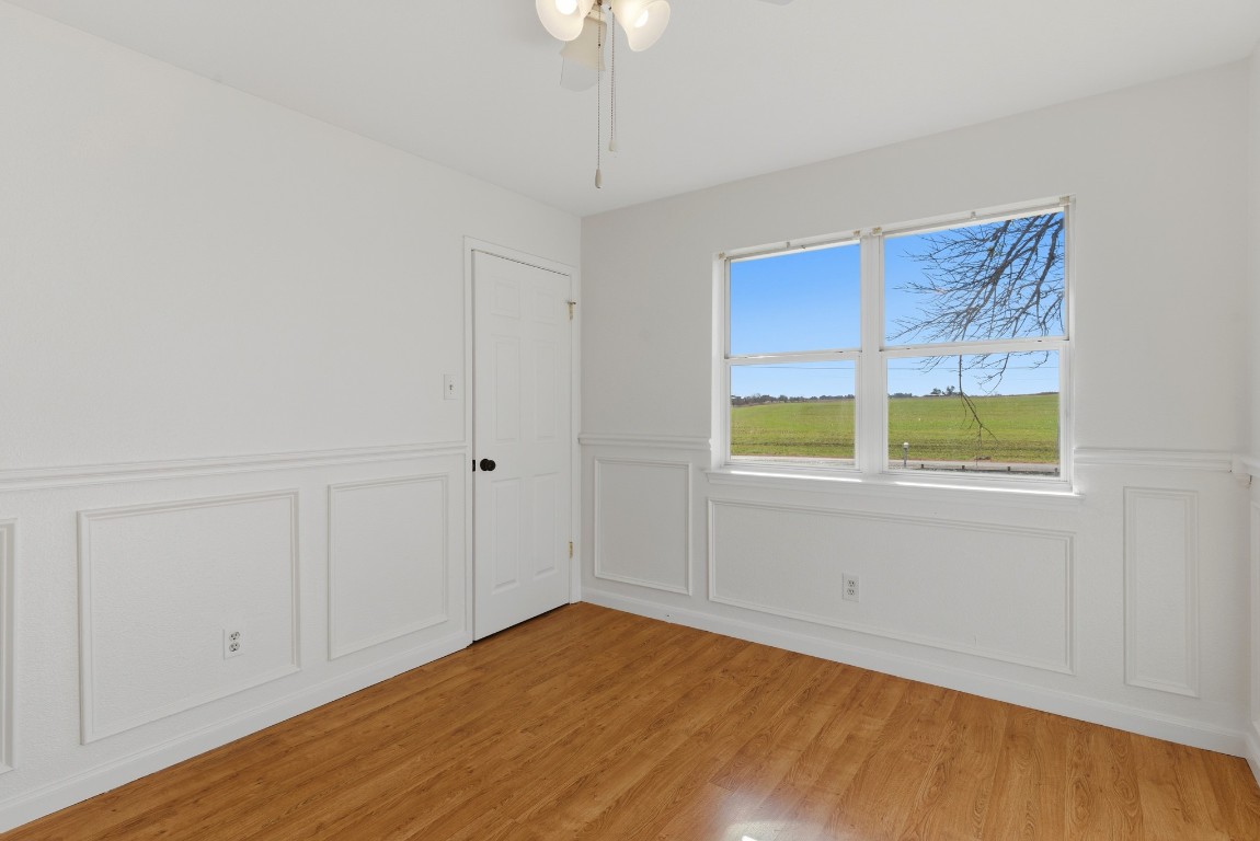 93 County Road 130 Georgetown, TX 78626 - Photo 20 of 27 a view of an empty room with wooden floor and windows