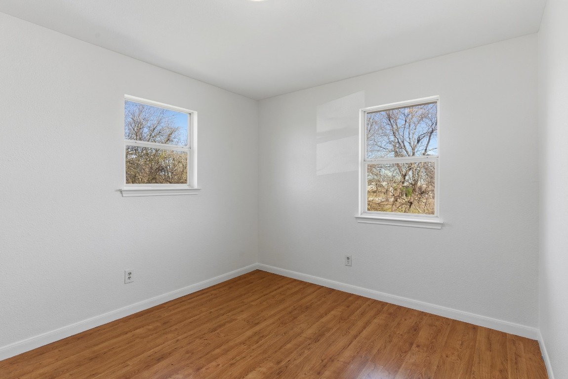 93 County Road 130 Georgetown, TX 78626 - Photo 23 of 27 a view of an empty room with wooden floor and a window
