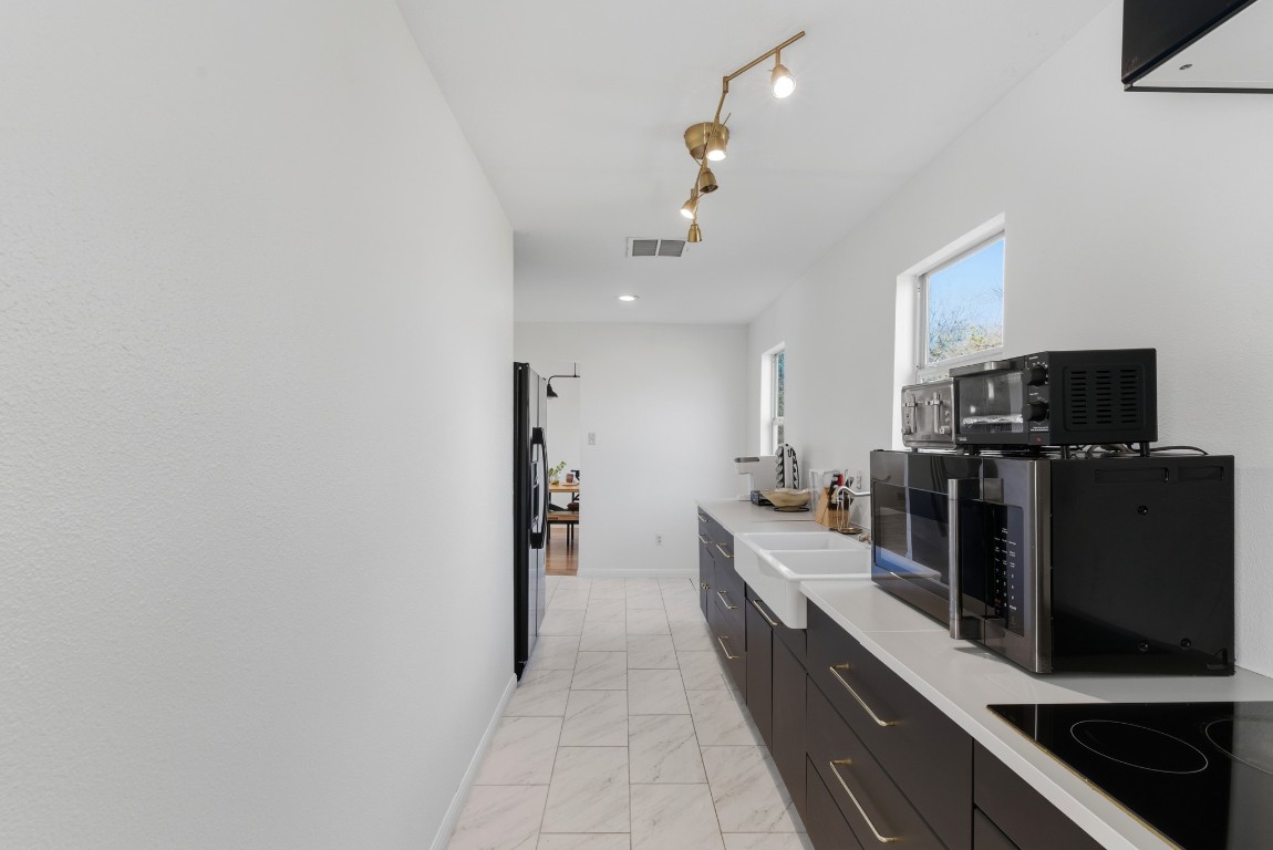 93 County Road 130 Georgetown, TX 78626 - Photo 5 of 27 a large kitchen with a large counter top appliances and cabinets