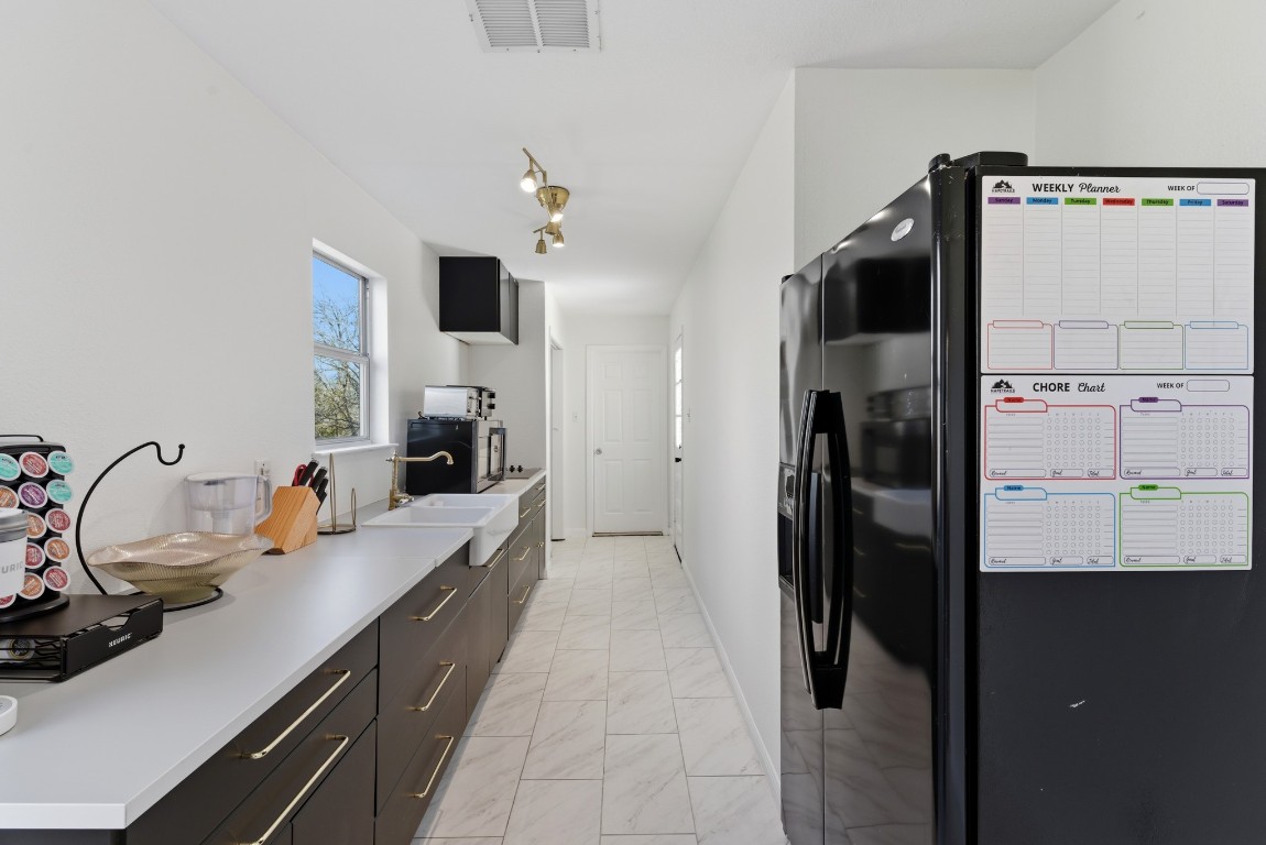 93 County Road 130 Georgetown, TX 78626 - Photo 7 of 27 a kitchen with refrigerator and sink