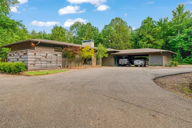 a view of a house with basket ball court and small yard