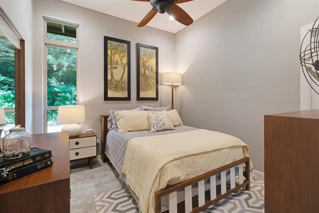 a bedroom with a bed a couch and a window