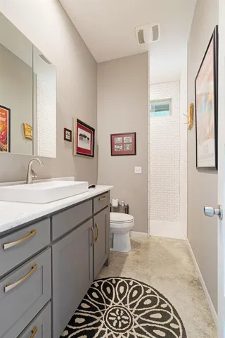 a spacious bathroom with a sink and a mirror