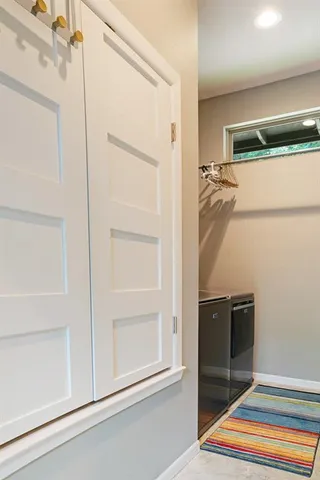 a view of walk in closet with empty racks