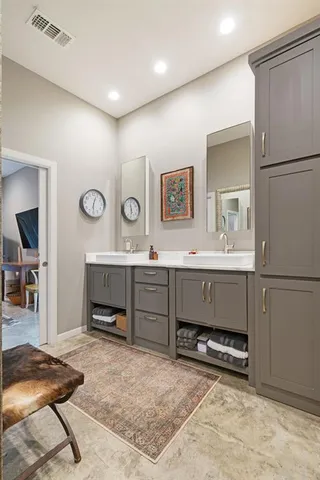 a en suite bathroom with a double vanity sink and a mirror