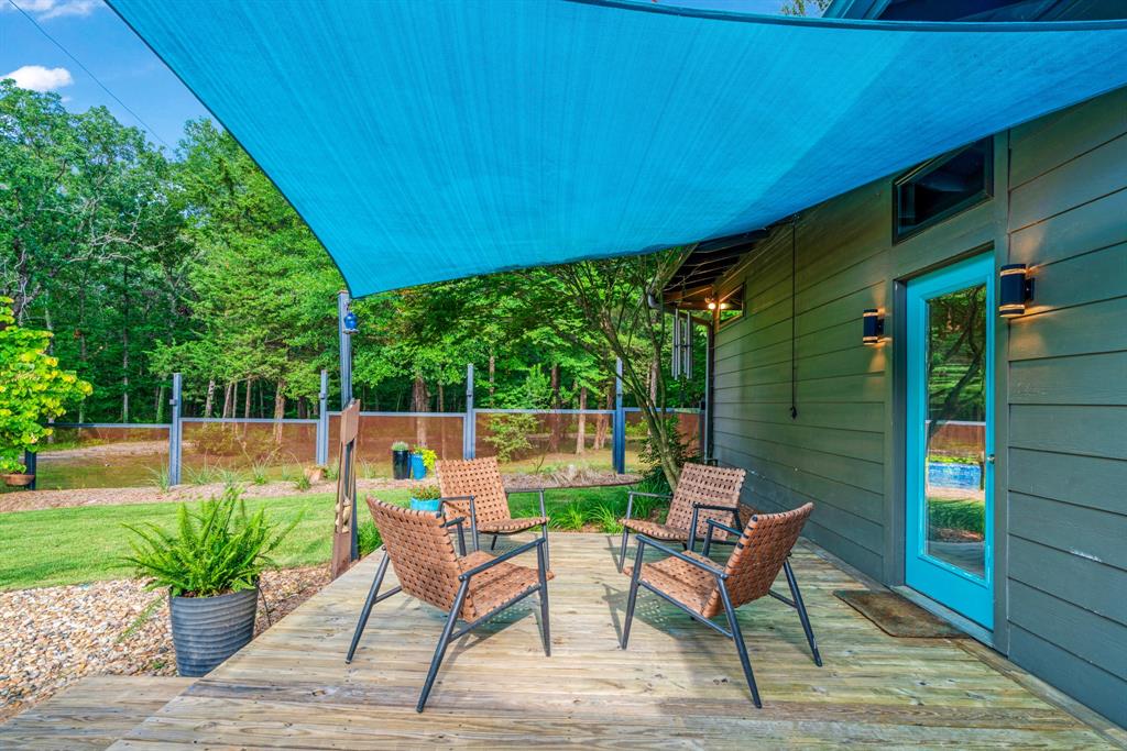 323 County Road Powderly, TX 75473 - Photo 22 of 36 a view of a chairs and table in the patio