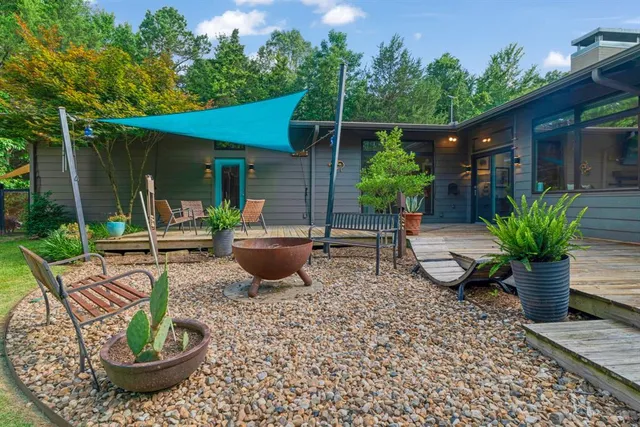 a view of a patio with chairs and plants