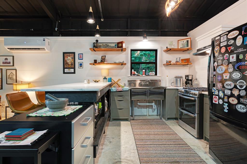 323 County Road Powderly, TX 75473 - Photo 31 of 36 a kitchen with stainless steel appliances granite countertop a sink stove and refrigerator