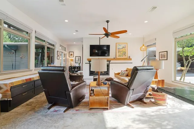 a living room with furniture a flat screen tv and a fireplace