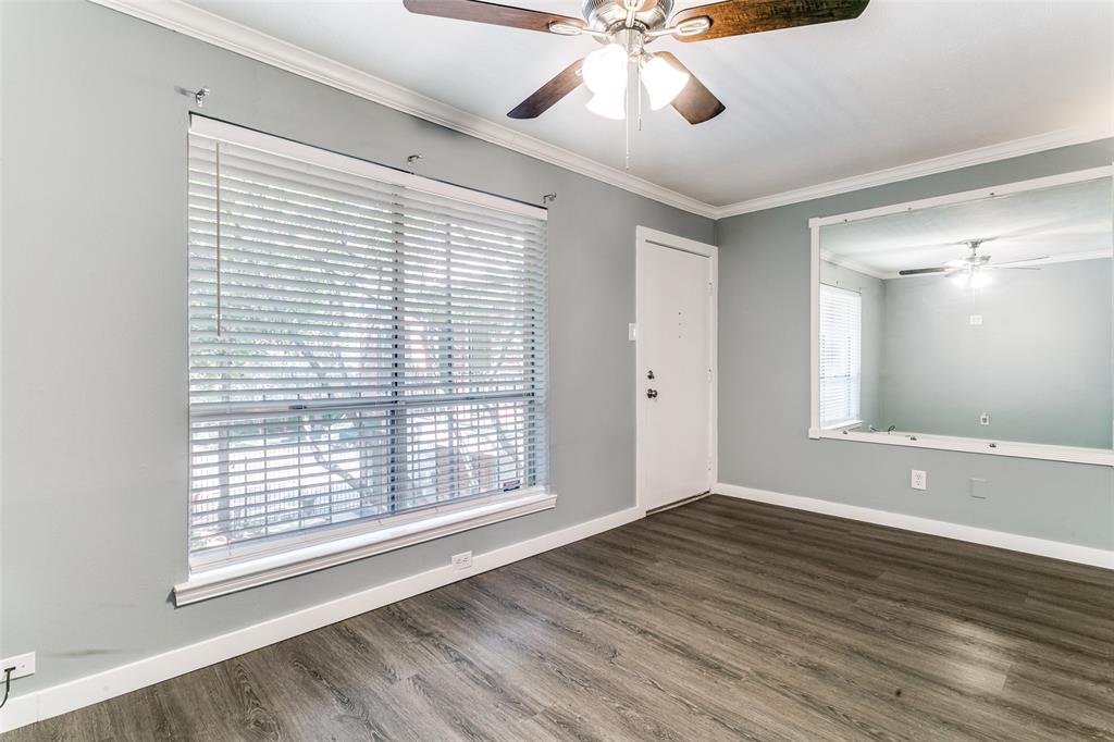 4525 Gilbert Avenue, Unit 203 Dallas, TX 75219 - Photo 3 of 6 a view of an empty room with wooden floor and a window