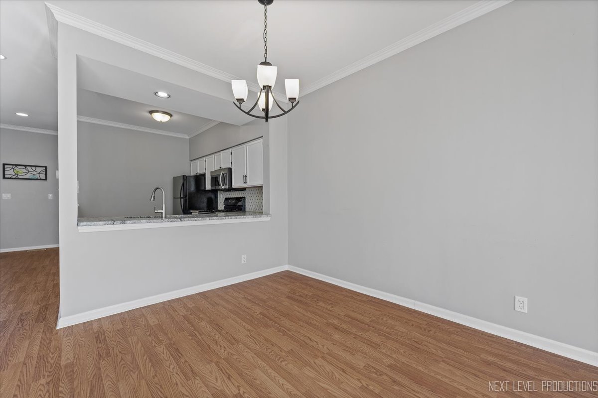 1441 Walnut Hill Avenue St. Charles, IL 60174 - Photo 11 of 22 a view of a kitchen with a microwave and a ceiling fan