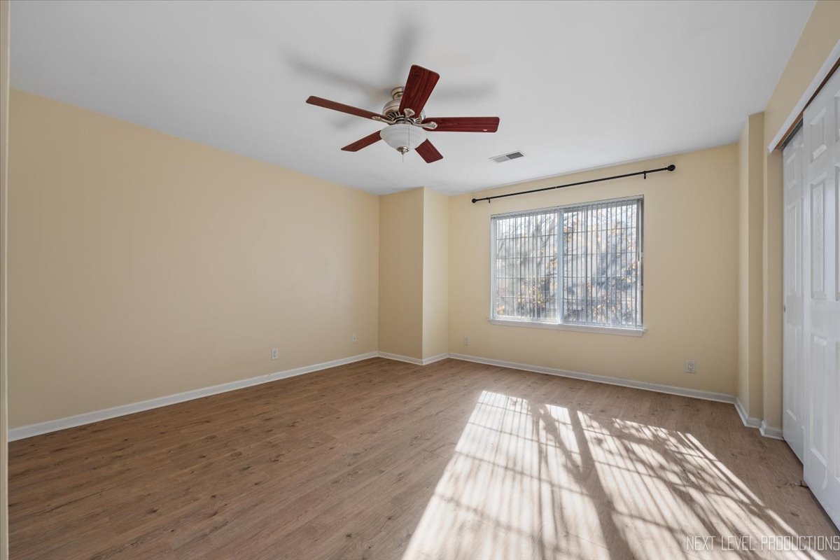 1441 Walnut Hill Avenue St. Charles, IL 60174 - Photo 13 of 22 a view of empty room with wooden floor and fan