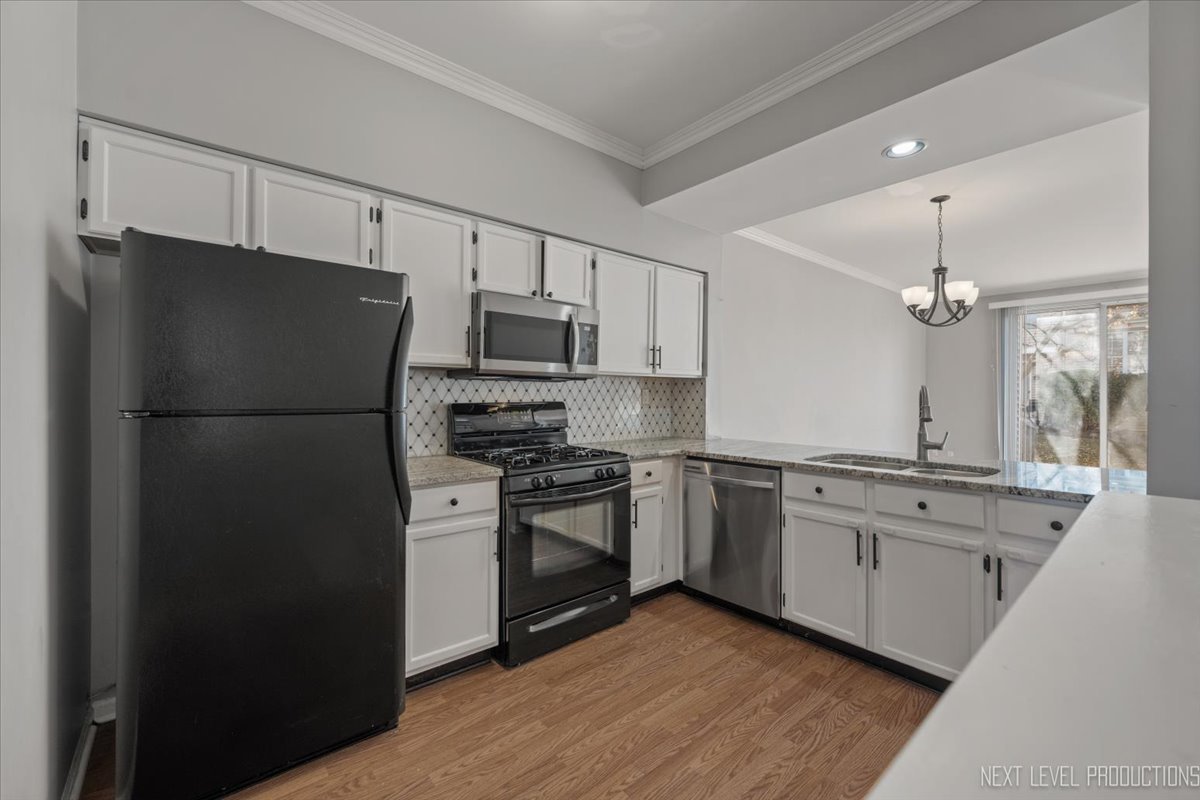 1441 Walnut Hill Avenue St. Charles, IL 60174 - Photo 4 of 22 a kitchen with a refrigerator stove and sink