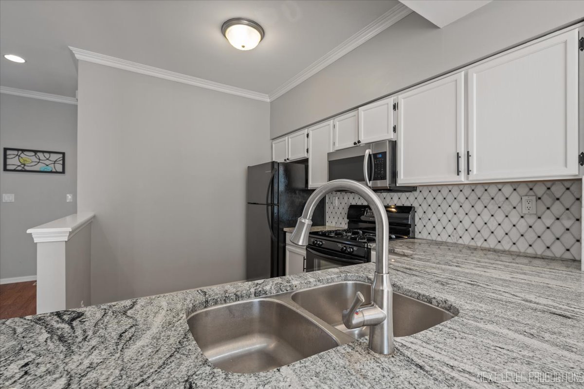 1441 Walnut Hill Avenue St. Charles, IL 60174 - Photo 5 of 22 a kitchen with granite countertop a sink stainless steel appliances and cabinets