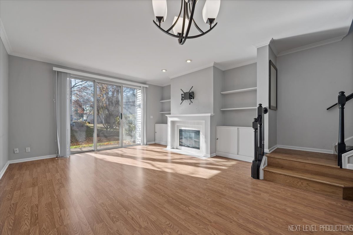 1441 Walnut Hill Avenue St. Charles, IL 60174 - Photo 7 of 22 a view of empty room with wooden floor and fireplace