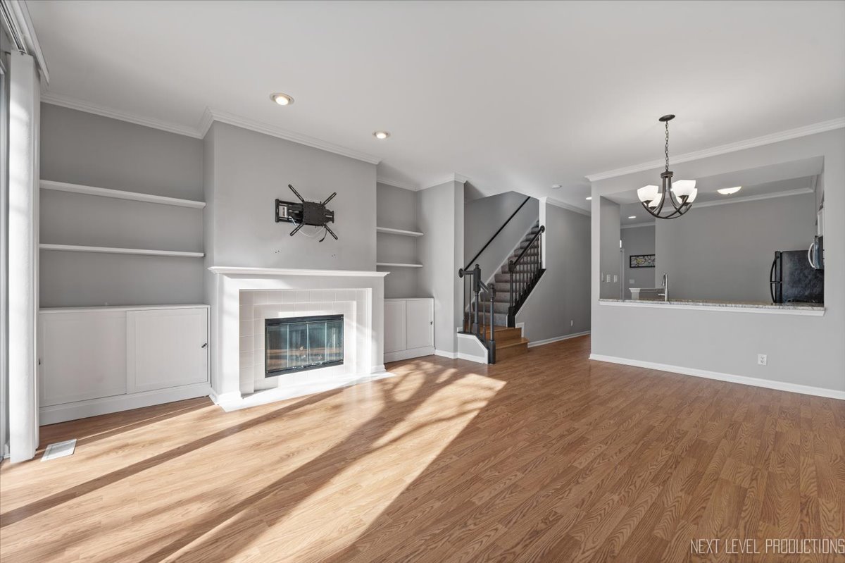 1441 Walnut Hill Avenue St. Charles, IL 60174 - Photo 8 of 22 a view of a livingroom with a fireplace and chandelier
