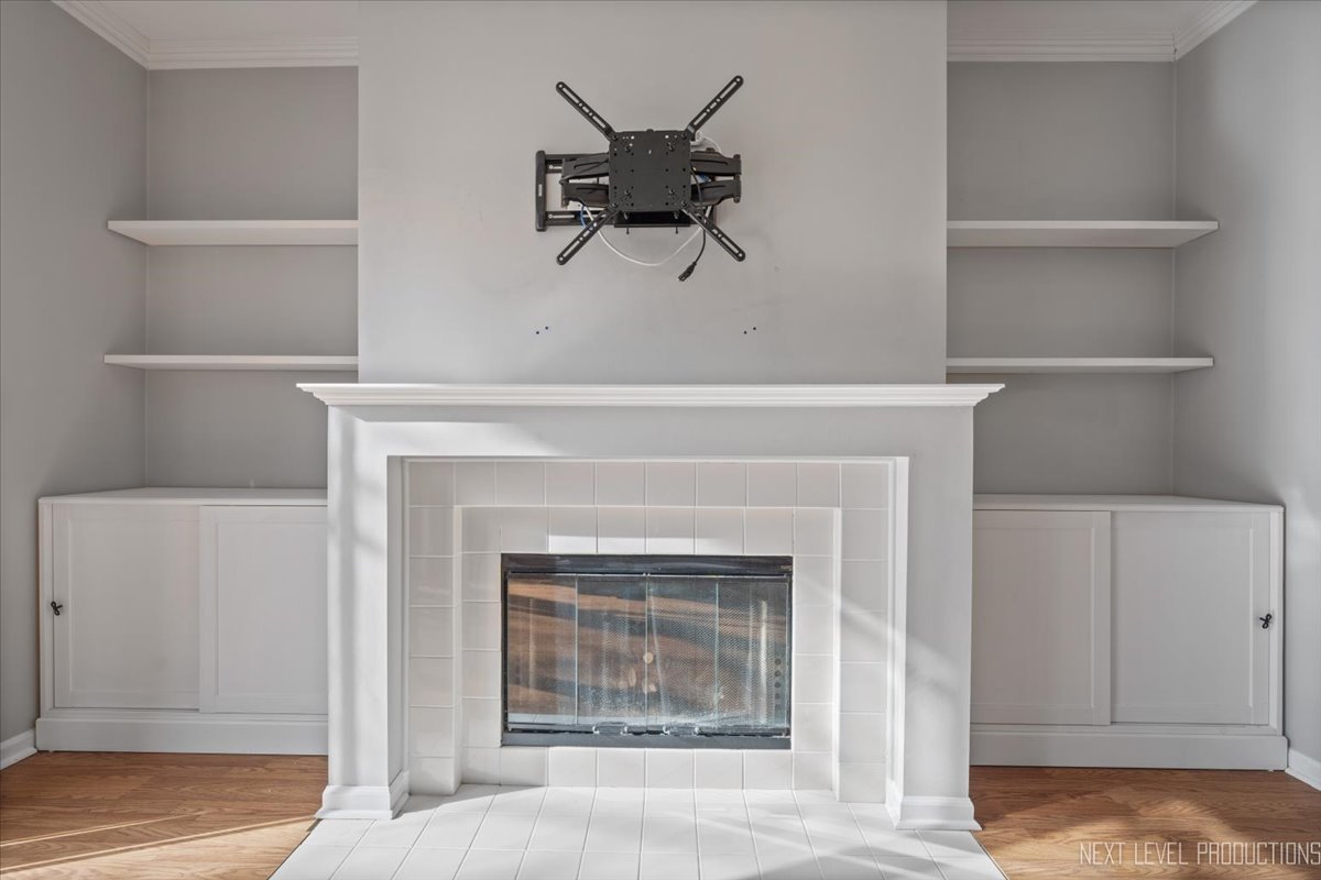 1441 Walnut Hill Avenue St. Charles, IL 60174 - Photo 10 of 22 a living room with a fireplace cabinet and a fireplace