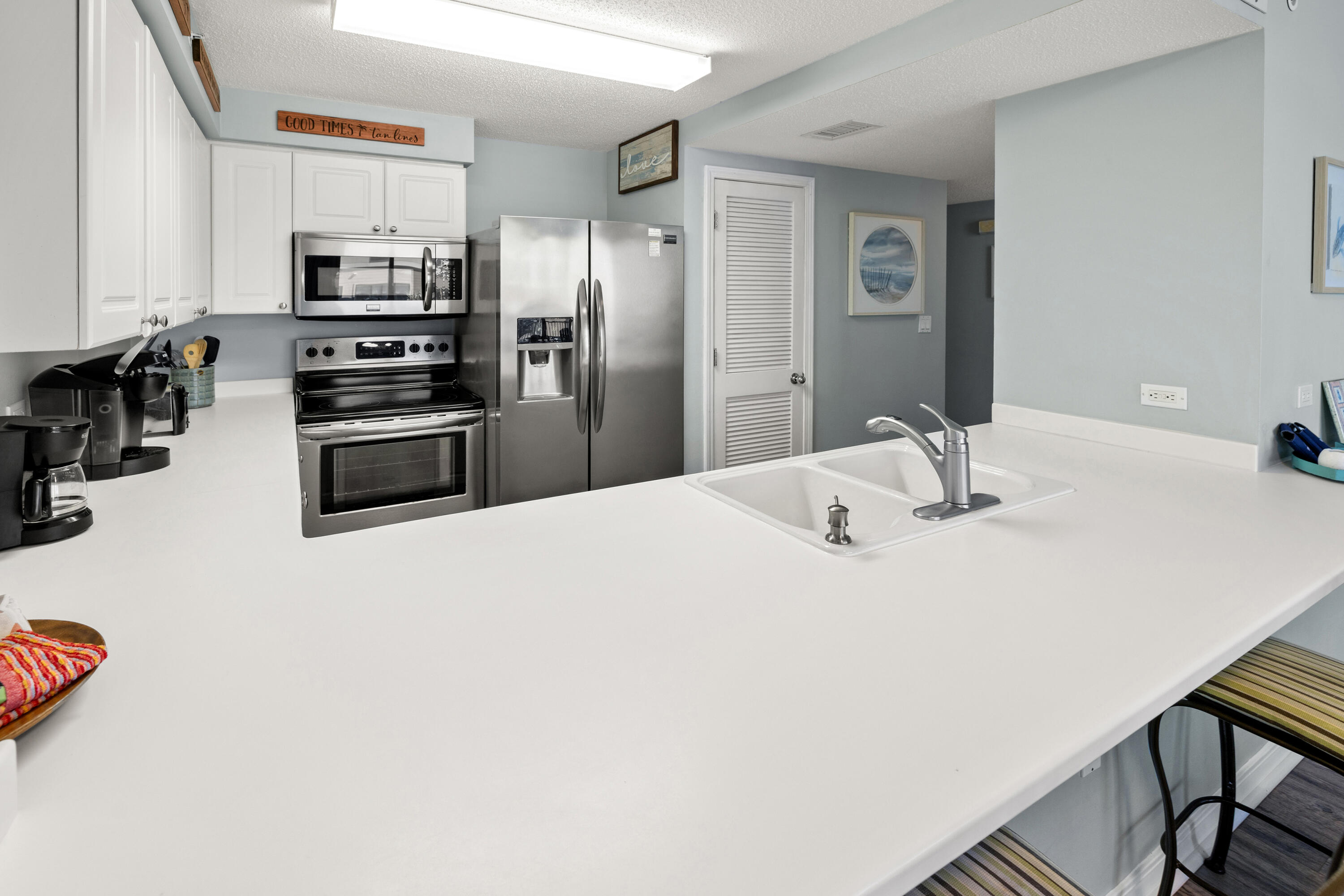 520 Santa Rosa Boulevard, Unit 319 Fort Walton Beach, FL 32548 - Photo 13 of 43 a kitchen with stainless steel appliances a refrigerator and a stove top oven